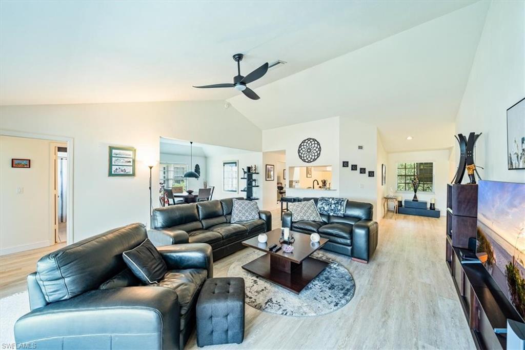 231 Via Perignon, Unit 204 Naples, FL 34119 - Photo 8 of 26 a living room with furniture or couch and a wooden floor