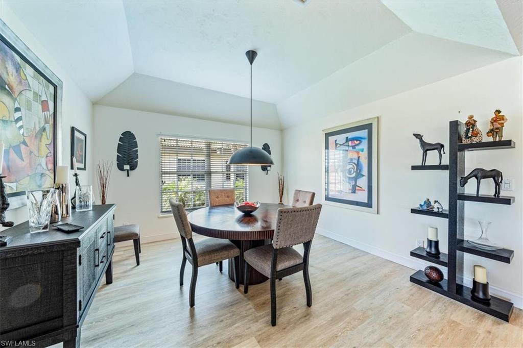 231 Via Perignon, Unit 204 Naples, FL 34119 - Photo 9 of 26 a dining room with furniture and wooden floor