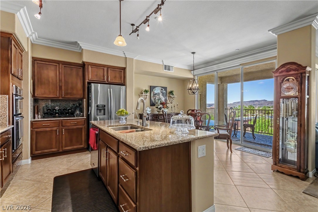 2555 Hampton Road, Unit 3308 Henderson, NV 89052 - Photo 14 of 65 An inviting kitchen with granite counters and stainless steel appliances flows seamlessly to an outdoor patio with mountain views.