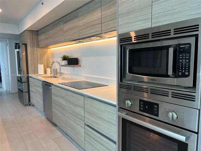 a kitchen with appliances and cabinets