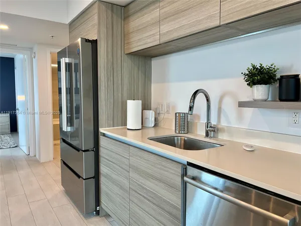 a kitchen with a refrigerator and a sink