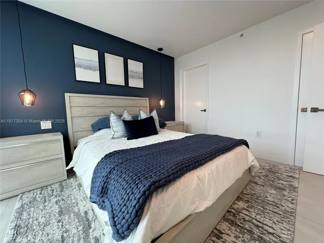 a bedroom with a bed and a night stand