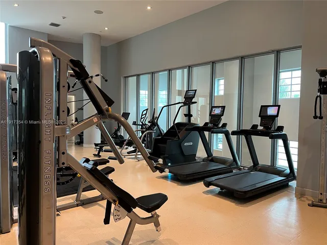 a room with gym equipment and windows