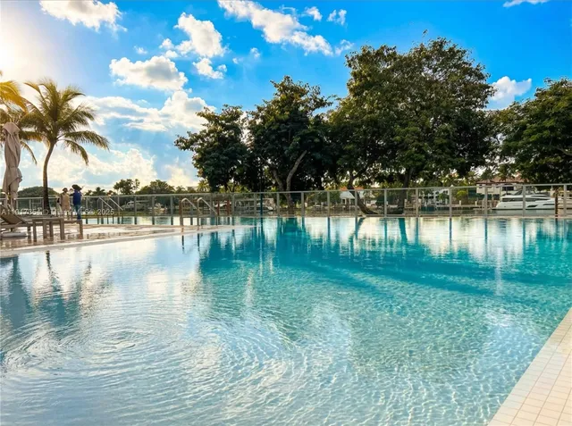 a view of pool with outdoor space and lake view