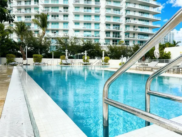 a view of swimming pool with outdoor seating