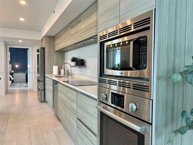 a kitchen with stainless steel appliances a stove and a sink