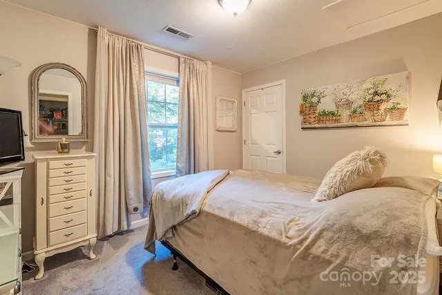 a bedroom with a bed and with furniture