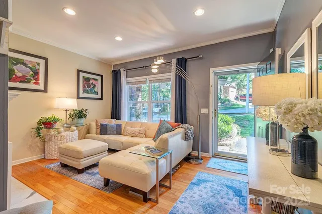 a living room with furniture fireplace and a large window