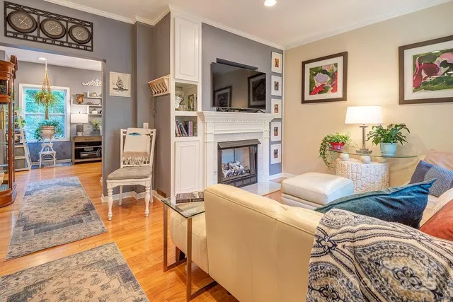 a living room with furniture a flat screen tv and a fireplace