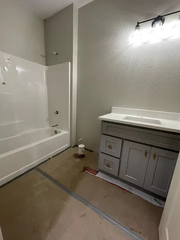 a bathroom with a sink a toilet and bathtub