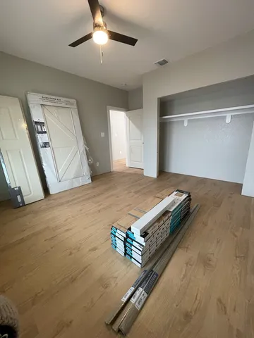 a view of a livingroom with wooden floor and a window