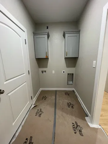 an empty room with a empty space and windows