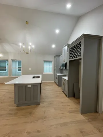 a kitchen with stainless steel appliances kitchen island granite countertop a refrigerator a sink and a stove