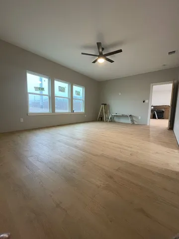 a view of a livingroom with a ceiling fan and window