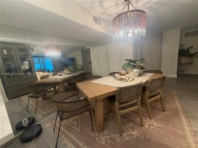 a view of a dining room with furniture and chandelier