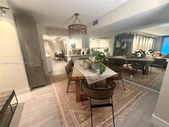 a view of a dining room with furniture and chandelier