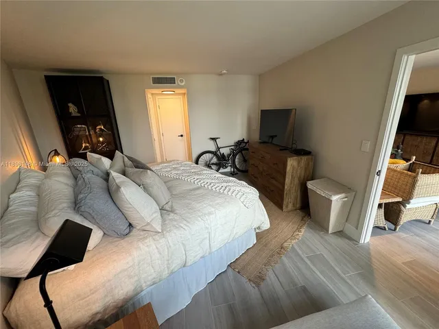a bedroom with two bed and a flat screen tv