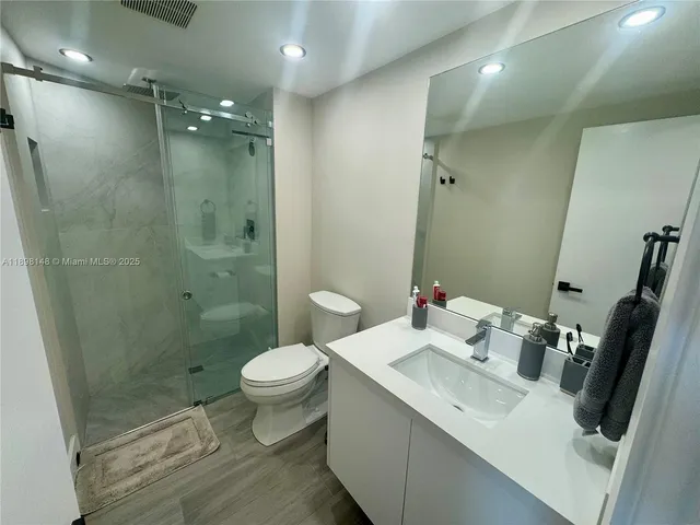 a bathroom with a sink toilet and shower