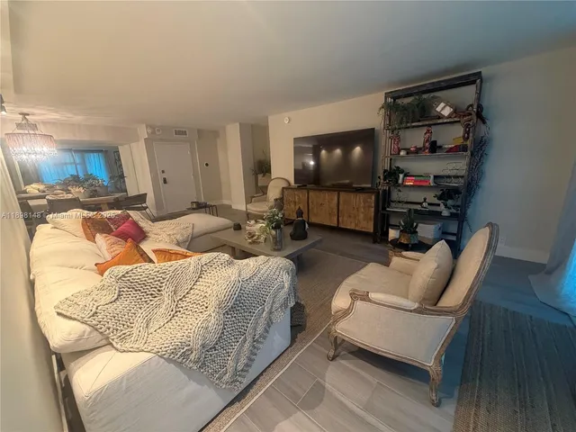 a bedroom with furniture and a flat screen tv