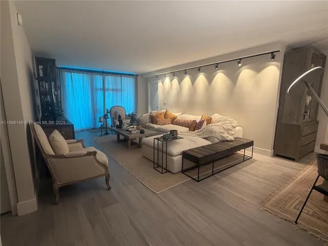 a living room with furniture and a large window