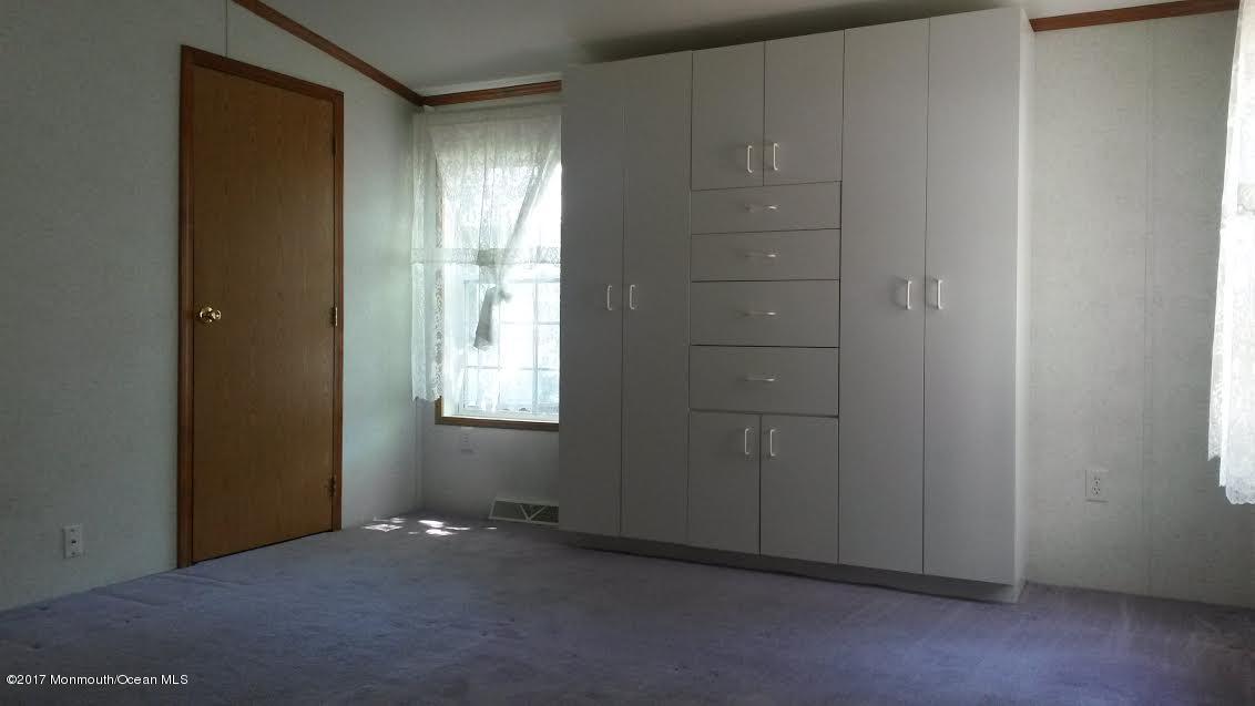 30 Village Road Morganville, NJ 07751 - Photo 21 of 25 an empty room with windows and closet