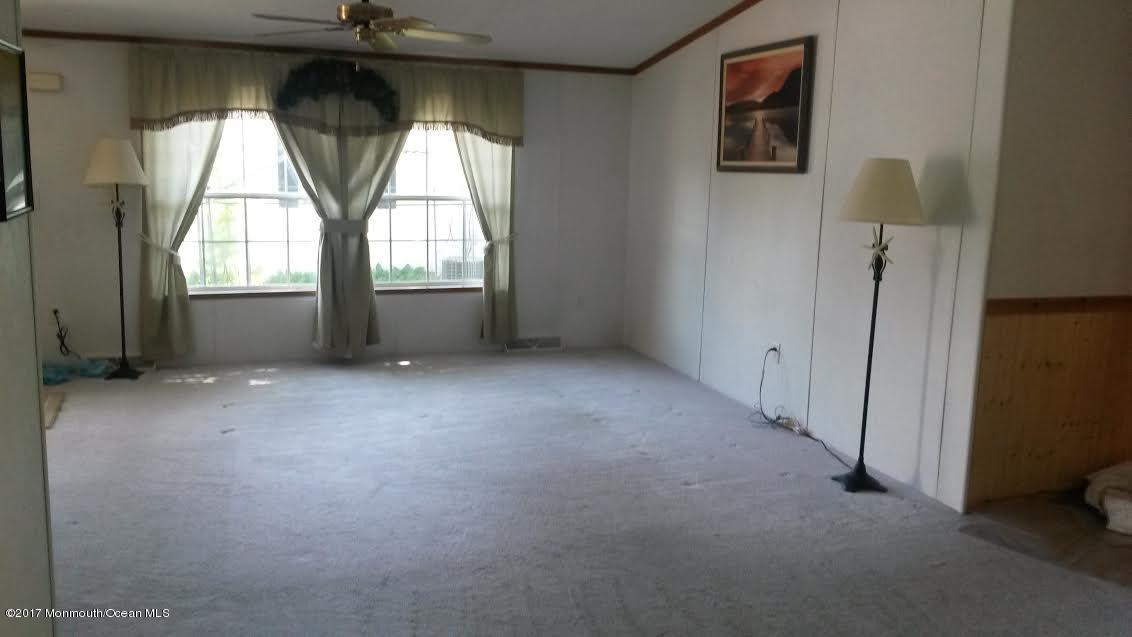 30 Village Road Morganville, NJ 07751 - Photo 5 of 25 an empty room with a empty space and windows