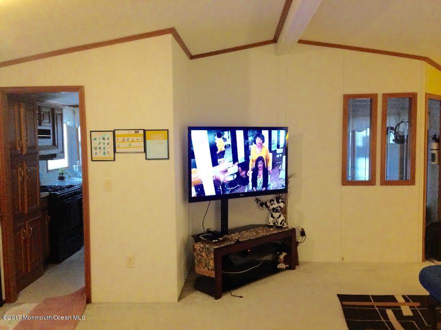 30 Village Road Morganville, NJ 07751 - Photo 7 of 25 a room with furniture and wooden floor