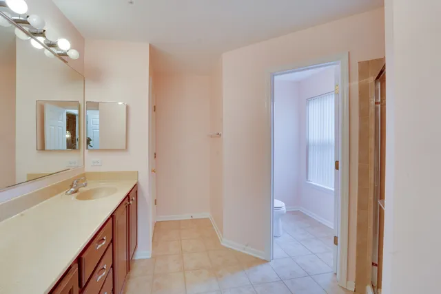 a bathroom with a tub sink and mirror
