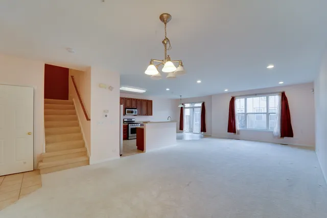 a view of a kitchen with a sink and a refrigerator