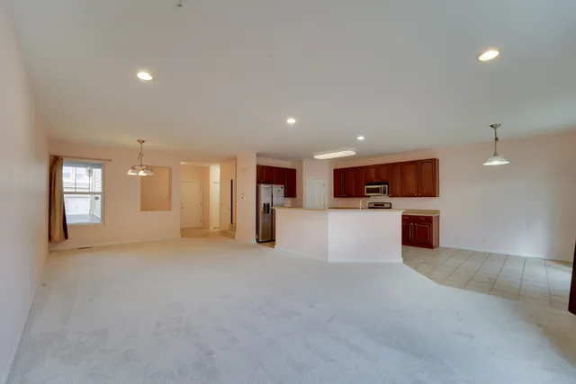 a kitchen with stainless steel appliances granite countertop a refrigerator a stove top oven a sink and dishwasher