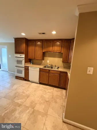 a kitchen with stainless steel appliances a refrigerator and a stove top oven