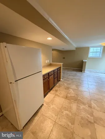 a kitchen with a refrigerator sink and cabinets