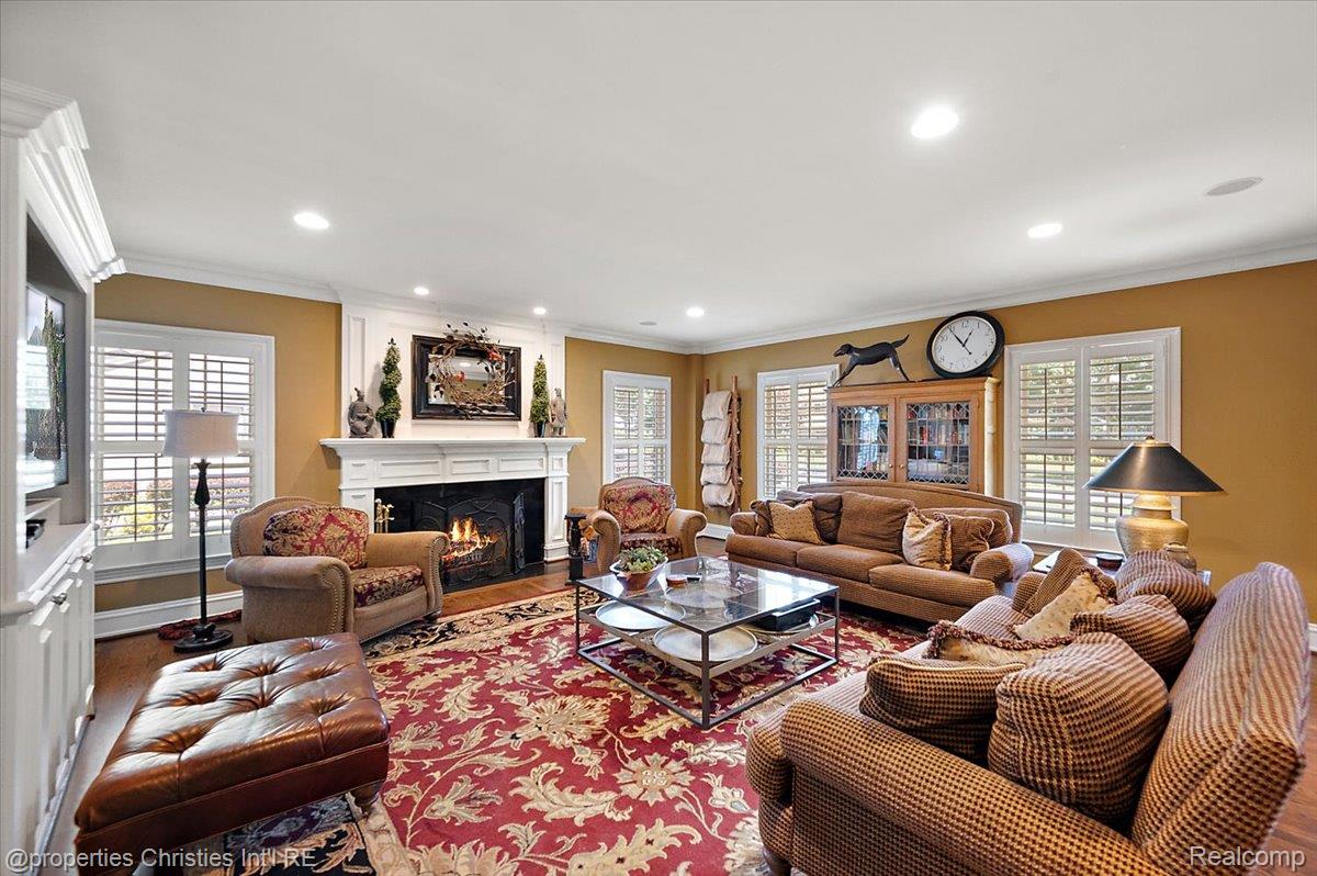 135 Clifton Road Bloomfield Hills, MI 48301 - Photo 30 of 77 Living area featuring a white wood-mantel fireplace, recessed lighting, and multiple windows with white plantation shutters
