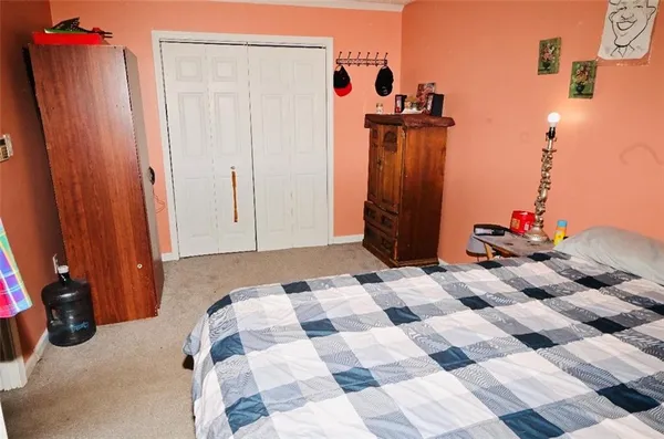 a bedroom with a bed and a closet