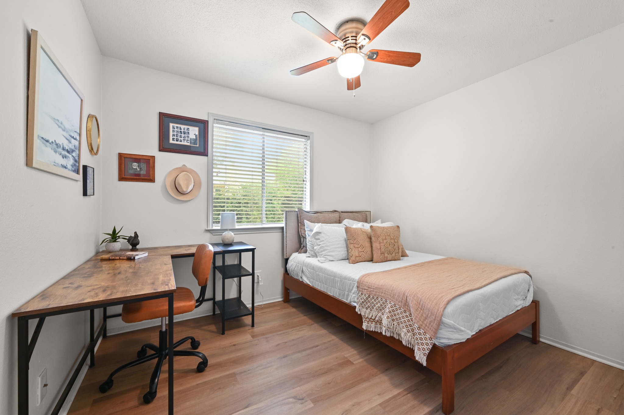 6805 Rearden Road Austin, TX 78745 - Photo 16 of 26 Well-lit room with wood-look flooring and a functional corner desk.