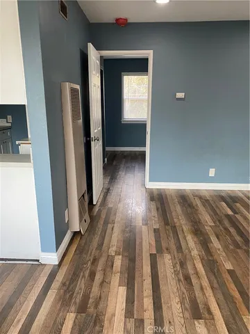 a view of hallway with wooden floor