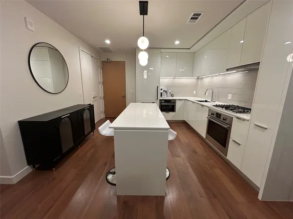 a kitchen with sink stove and refrigerator