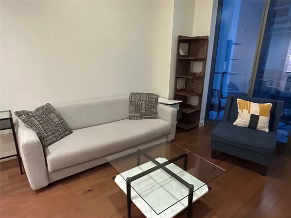 a living room with furniture and a wooden floor