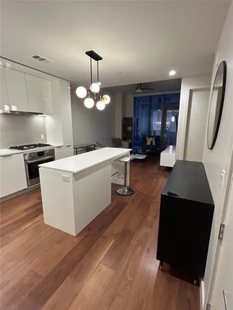 a view of a kitchen counter space wooden floor and a ceiling fan