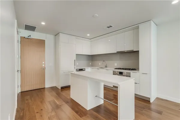 a kitchen with a stove a sink and a refrigerator