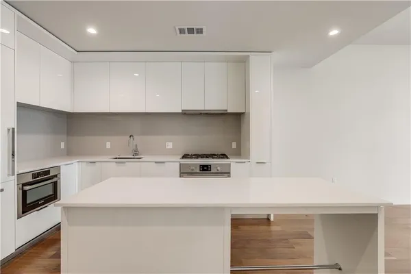a stove top oven sitting inside of a kitchen
