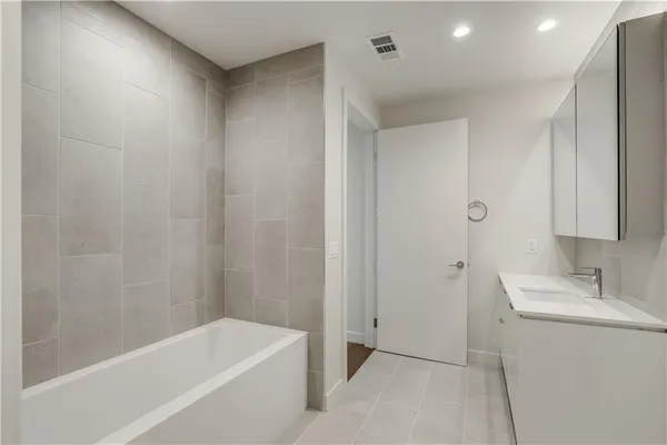 a bathroom with a bathtub and a sink