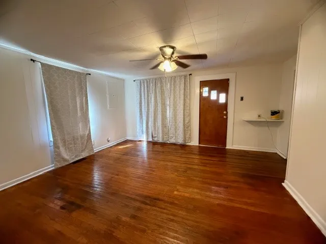 wooden floor in an empty room with a window
