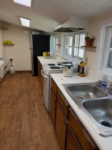 a kitchen with sink cabinets and appliances