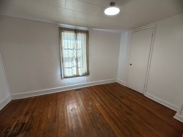 1758 Midway Road Sewanee, TN 37375 - Photo 7 of 15 an empty room with wooden floor and windows