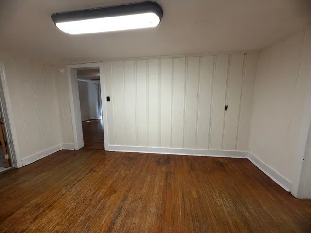 a view of an empty room and wooden floor