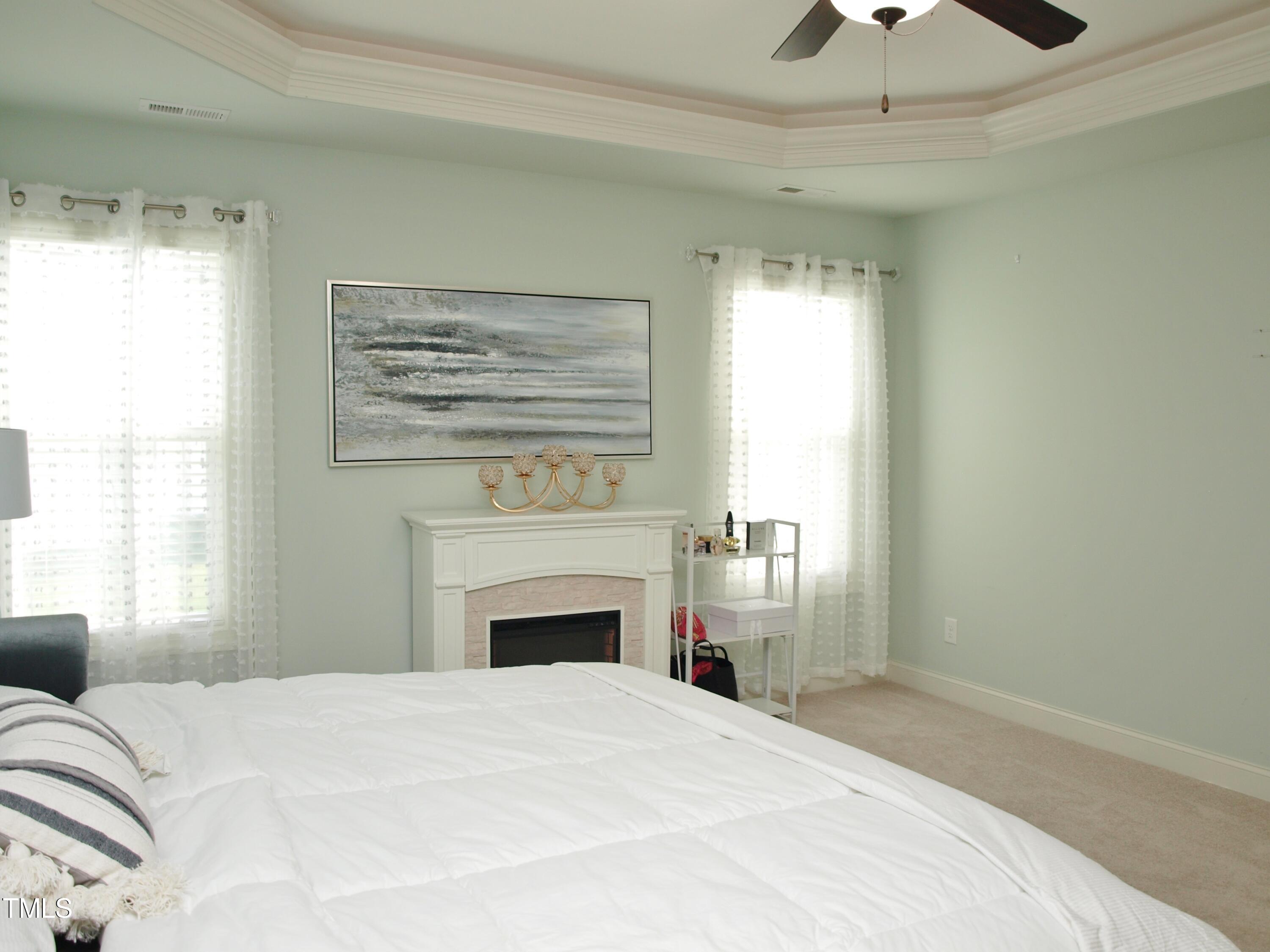 417 Airedale Trail Garner, NC 27529 - Photo 15 of 26 a bedroom with a bed and a fireplace