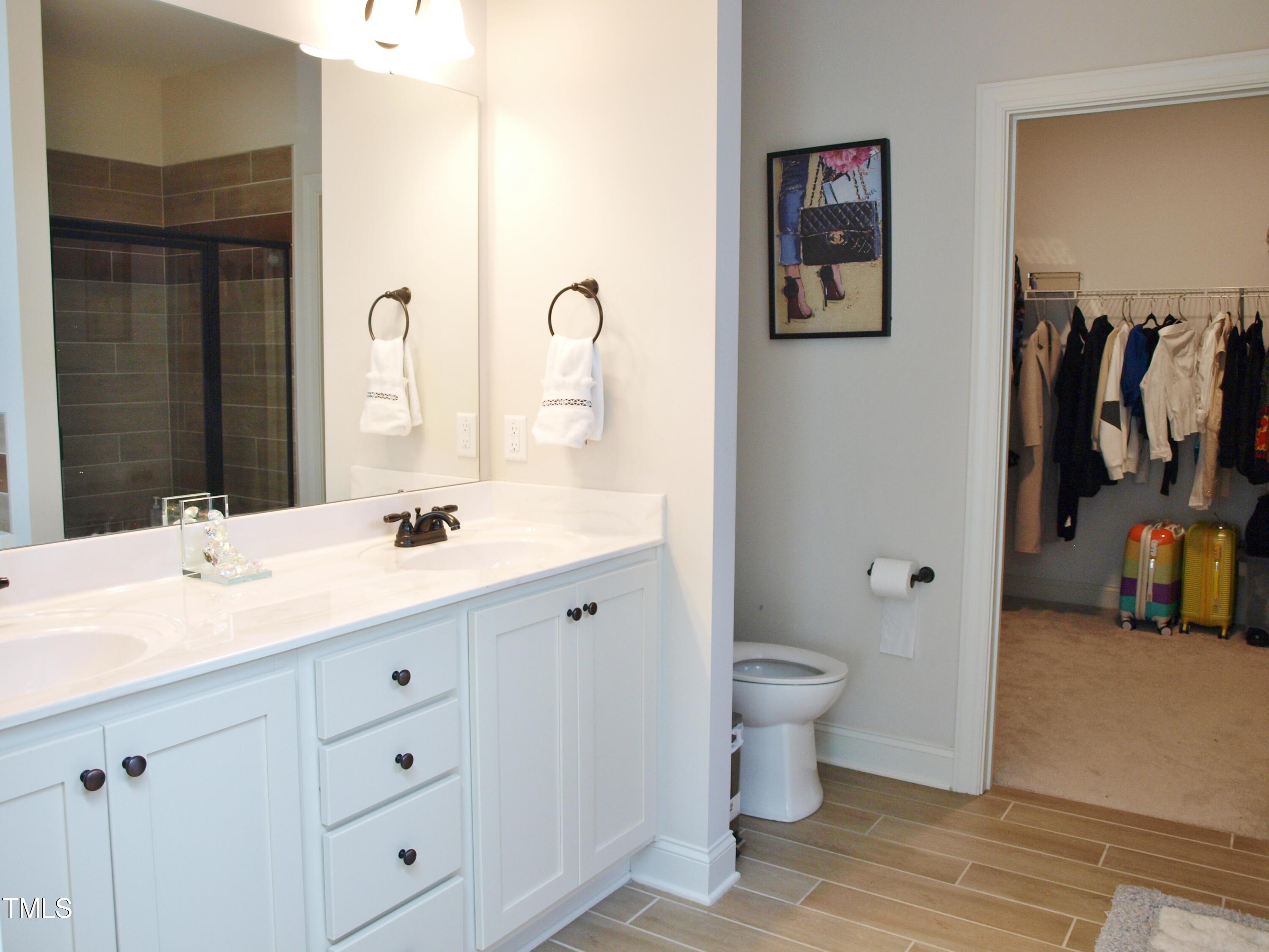 417 Airedale Trail Garner, NC 27529 - Photo 16 of 26 a bathroom with a double vanity sink and a toilet