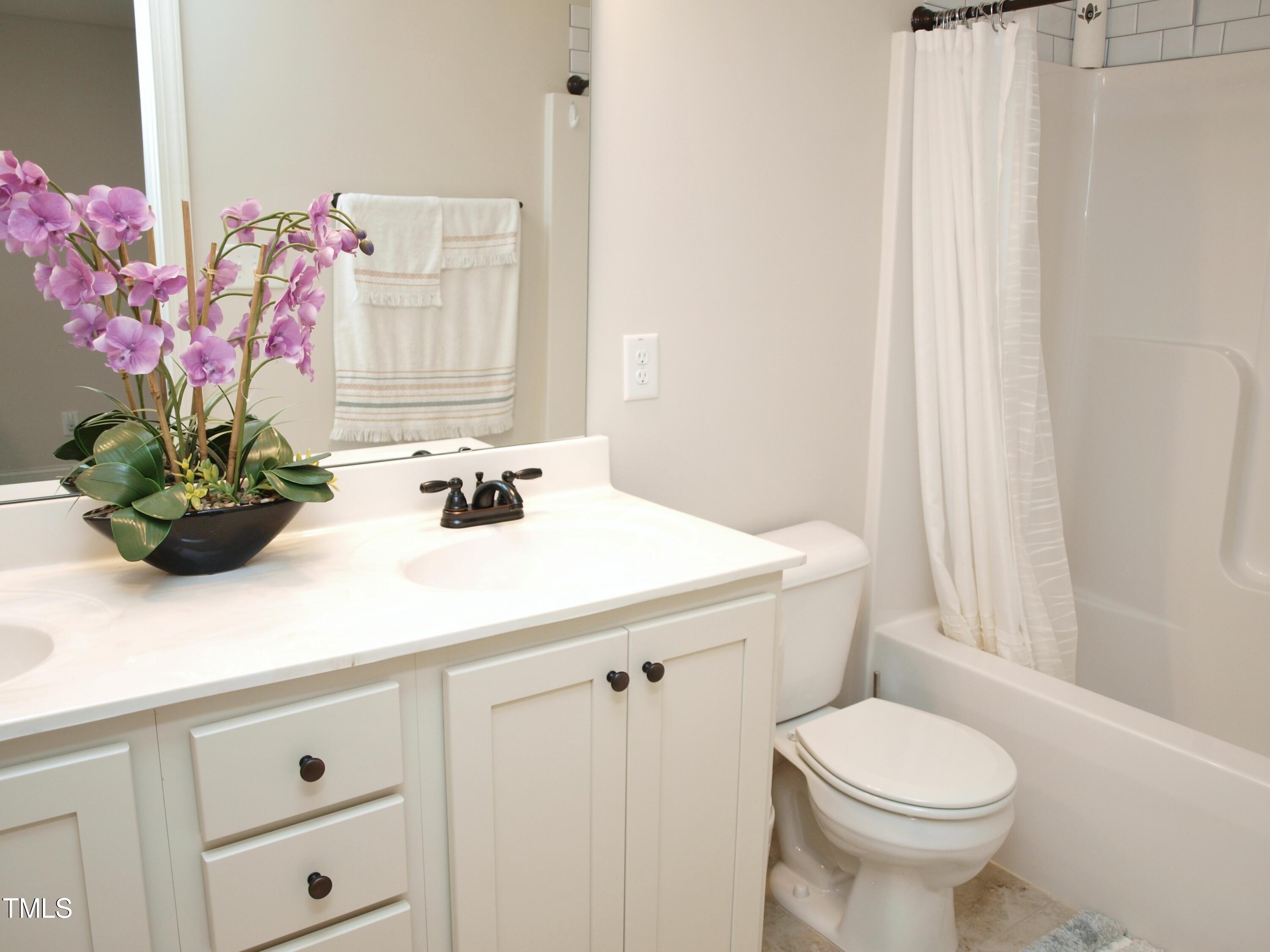 417 Airedale Trail Garner, NC 27529 - Photo 21 of 26 a bathroom with a sink a vanity and a mirror