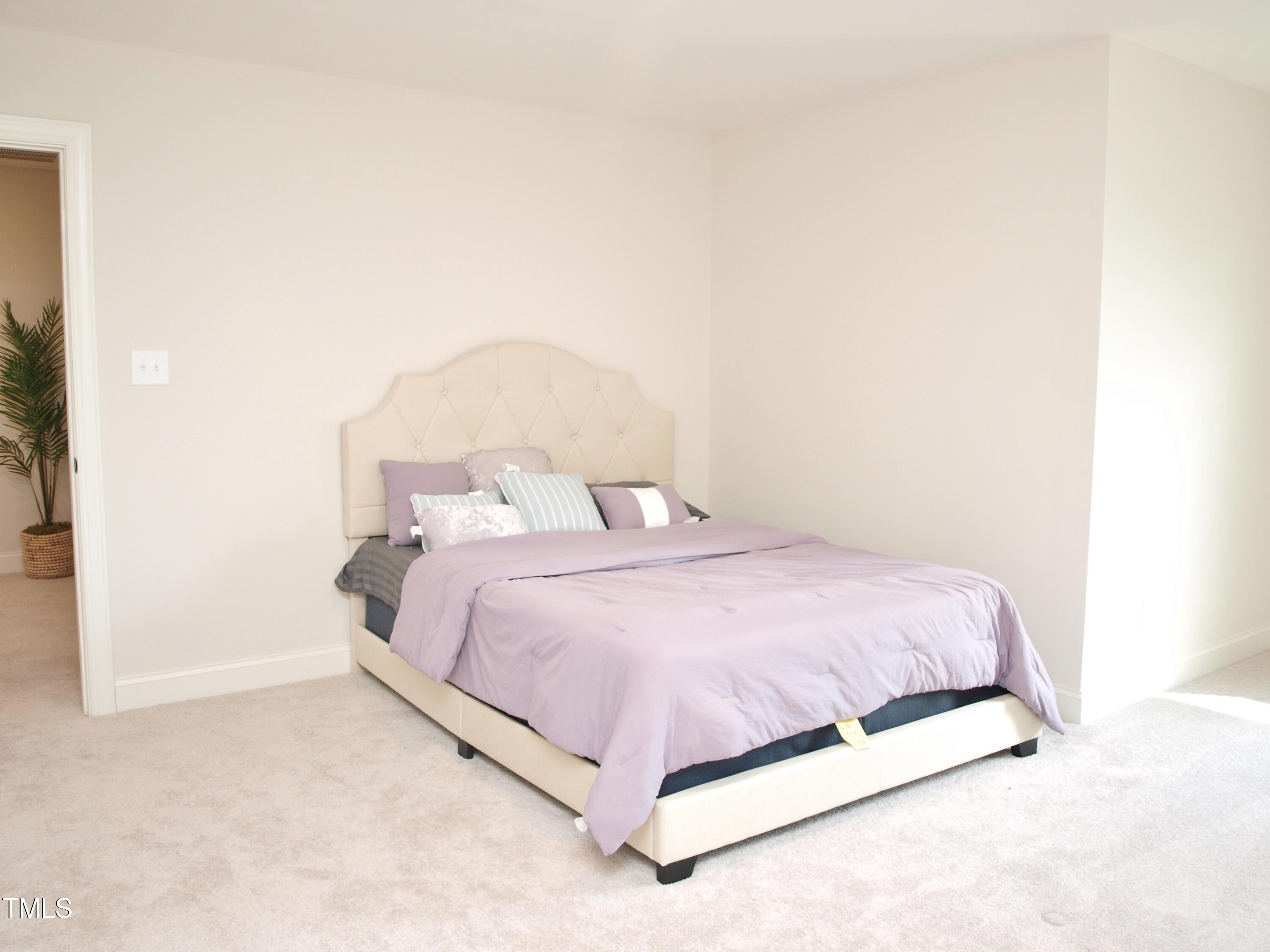 417 Airedale Trail Garner, NC 27529 - Photo 22 of 26 a large bed sitting in a bedroom next to a bathroom